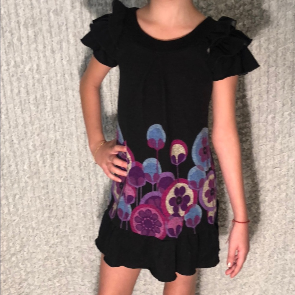 Girl’s black dress with printed flowers.